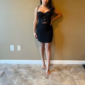 Black mini BEBE dress with center cut outs.